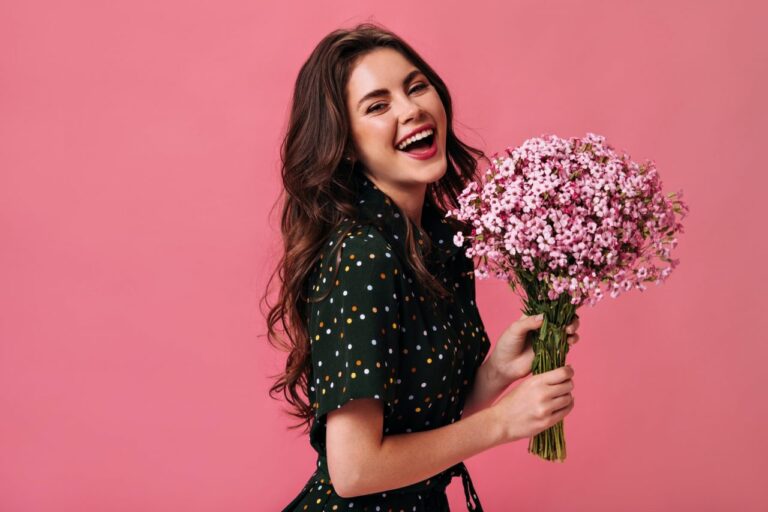 happy-woman-in-polka-dot-outfit-laughing-and-holding-flowers-young-girl-with-large-bouquet-of-smal.jpg